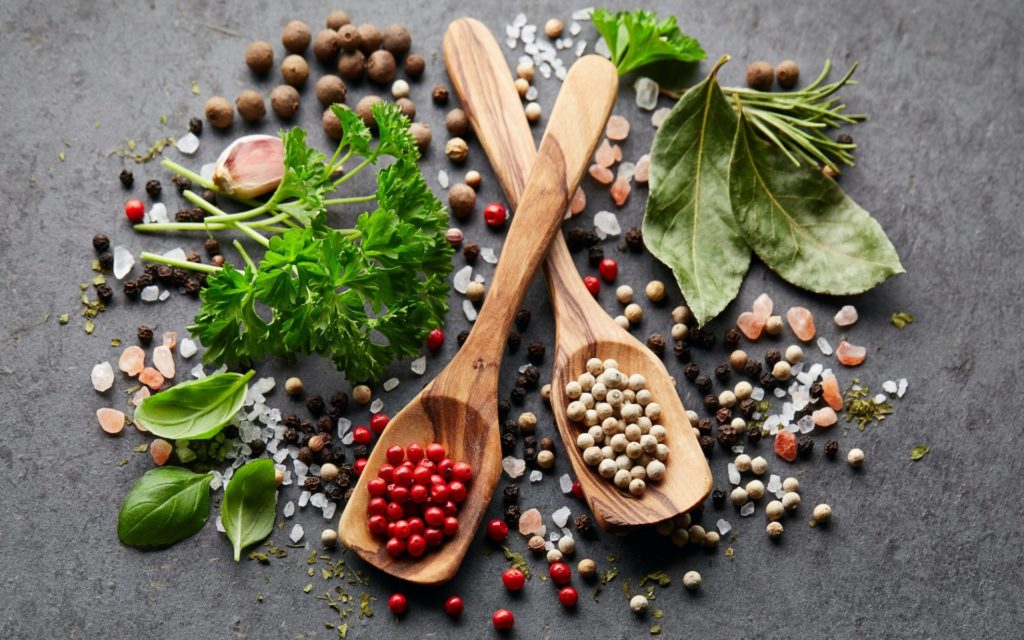 Spices and herbs on black board